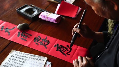 Vung Tau, Vietnam - March, 2017: Writing couplets for Spring Festival at Long Son, Vung Tau city. Calligraphy giving is a tradition popular for Spring holiday to Vietnamese people