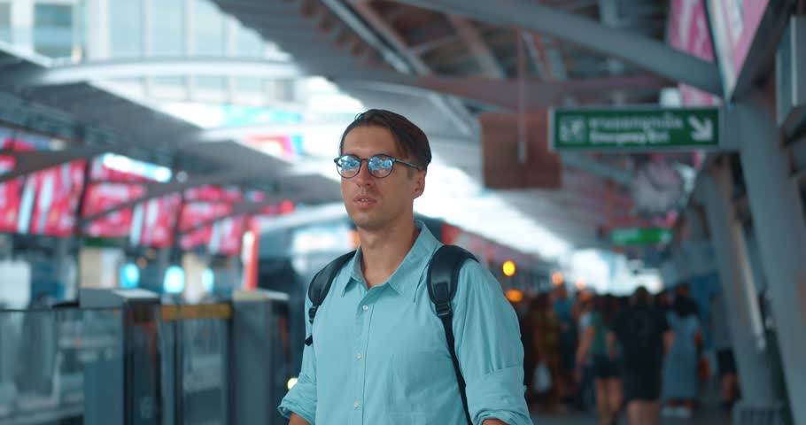 Millennial man stands at metro station, lost in thought and drinking coffee. At last minute, man saw train approaching and ran towards it. Man managed to catch last carriage of closing doors. Royalty-Free Stock Footage #3428352403