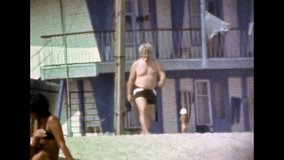 Funny cheerful man make fun excitement on summer beach vacation. Carefree man is have fun, rejoicing on sea holidays. Joyful person joking in recreation travel. Vintage color film. Retro archive 1980s