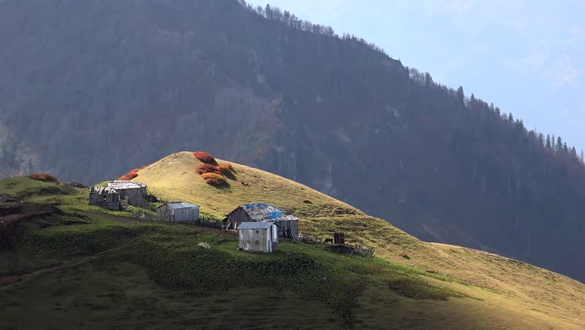 Highland houses on the ridge above the treeless hill in the mountain.