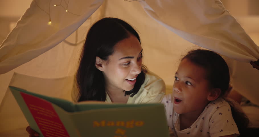 Mother, daughter and storytelling in tent with book and bonding together for child development in home. Woman, girl and relax indoor at night for fairytale stories, fun and love with excited to read Royalty-Free Stock Footage #3428598613