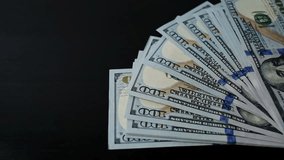 Casino chips one by one fall onto lying hundred dollar bills. Close-up, slow motion. Concept of casino, risk, gambling, addiction, bet on all money, all-in, place for text - Powered by Shutterstock - Get 15% off with code: PIKWIZARD15