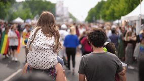 Little kid sit mother shoulders. Happy heterosexual family support lgbt community. Joy straight parents with two children have fun gay pride parade. Usual people among homosexual crowd. Queer culture. - Powered by Shutterstock - Get 15% off with code: PIKWIZARD15