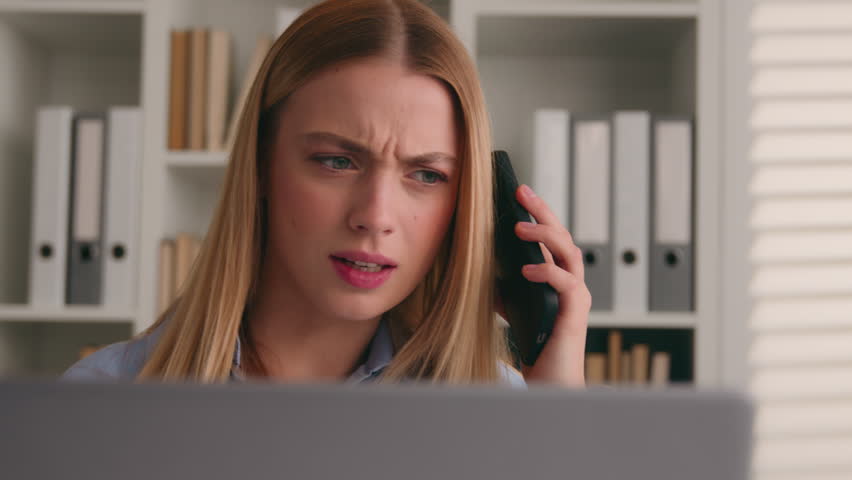 Confused Caucasian business woman student girl businesswoman dissatisfied with hearing bad smartphone sound female girl phone answer call listen in cellphone noisy terrible noise shocked in office Royalty-Free Stock Footage #3428710307