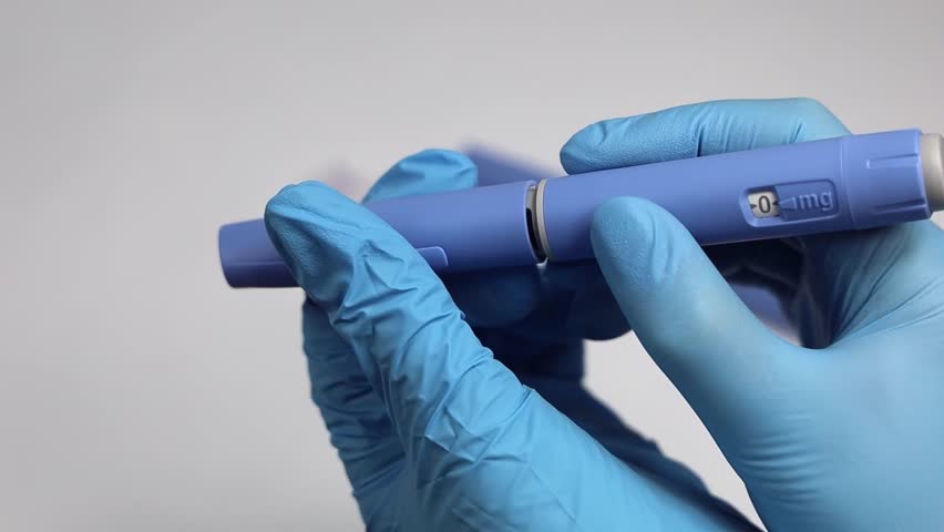 Hands in examination gloves demonstrate an injection with insulin for diabetics. Royalty-Free Stock Footage #3428742849