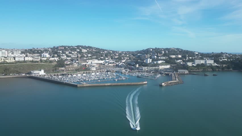 Torquay, Torbay, South Devon, England: DRONE VIEWS: The town of Torquay; Torquay marina and a speedboat leaving the marina at high speed. Torquay is a popular UK holiday resort (Clip 4).
