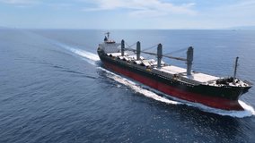 Aerial view of a bulk carrier cargo vessel traveling with high speed over the ocean - Powered by Shutterstock - Get 15% off with code: PIKWIZARD15
