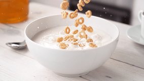 Circle-Shaped Whole Grain Cereals Falling into a White Bowl Filled with Milk in Slow Motion - Powered by Shutterstock - Get 15% off with code: PIKWIZARD15