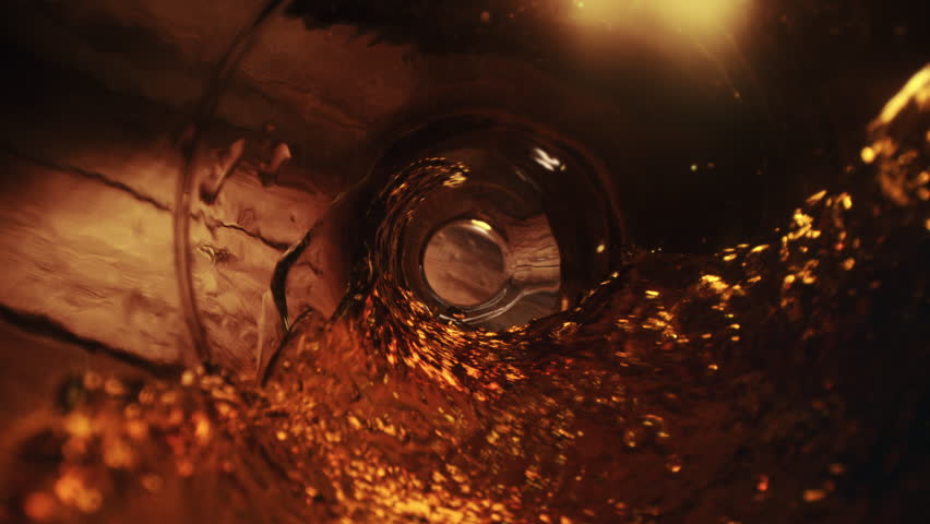 Beer Vortex Flowing through the Bottle Seen from the Inside in Slow Motion - Light Shines Through the Amber Glass Royalty-Free Stock Footage #3428917719