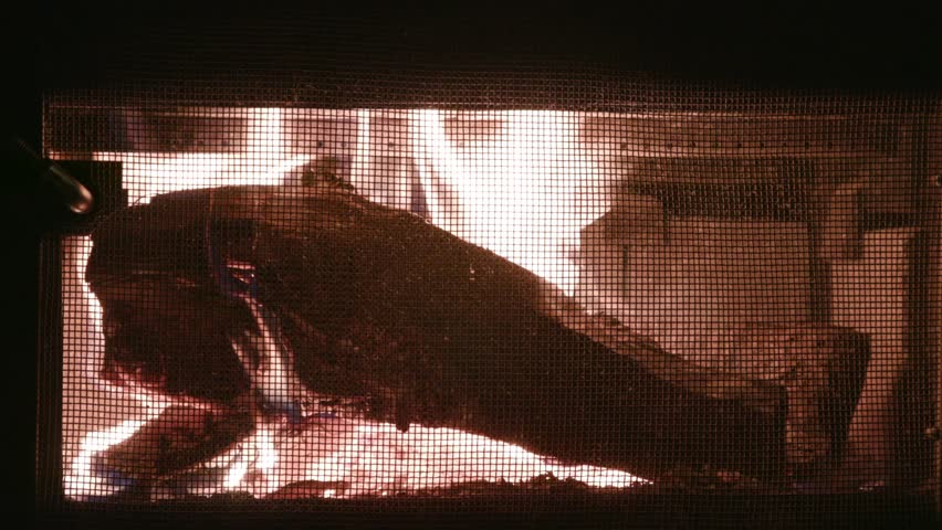 Wood burning and crackling in old cast iron fireplace in cabin Royalty-Free Stock Footage #3428973751