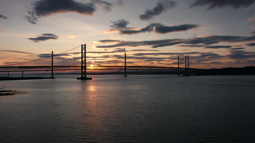Sunset at Forth Bridge Scotland United Kingdom aerial view with dramatic clouds