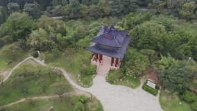Top down view of chinese pagoda temple in Nanjing, China. Drone video over Purple Zijin mountain. Panoramic view of woods in China with an old pagoda. Travel video in asia inside china.