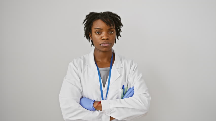 Nervous, skeptic young black woman in labcoat and dreadlocks, frowning in upset over a problem, emanating negative vibes. all alone against a stark white wall. doubt seems to cloud her thoughts. Royalty-Free Stock Footage #3429014553
