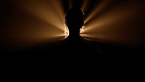 Flashing lights enhancing the silhouette of a woman in music video