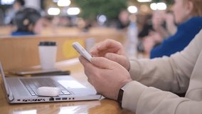 Side view. Hand of man using texting mobile phone of laptop chat in mall. Close up of man hand 4K - Powered by Shutterstock - Get 15% off with code: PIKWIZARD15