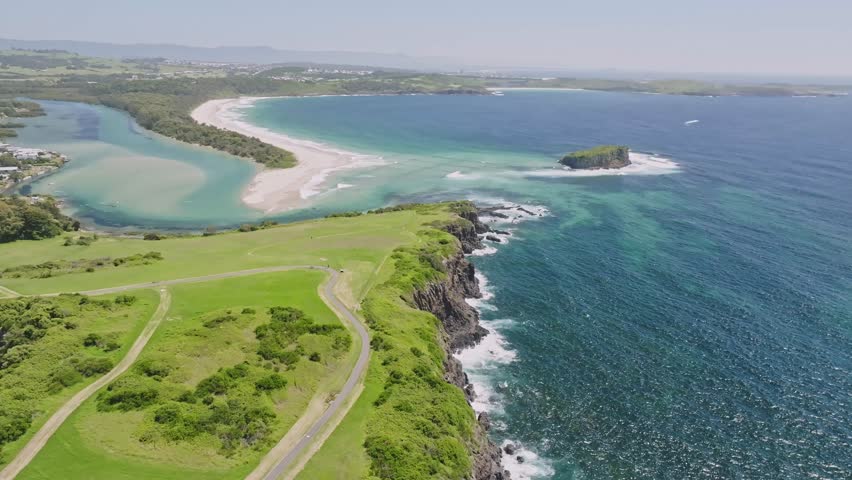 Stunning aerial drone flight over Minnamurra Point looking at Boyds Beach and Rangoon Island. Minnamurra is a coastal country town 120 kilometres south of Sydney, New South Wales, Australia Royalty-Free Stock Footage #3429123851