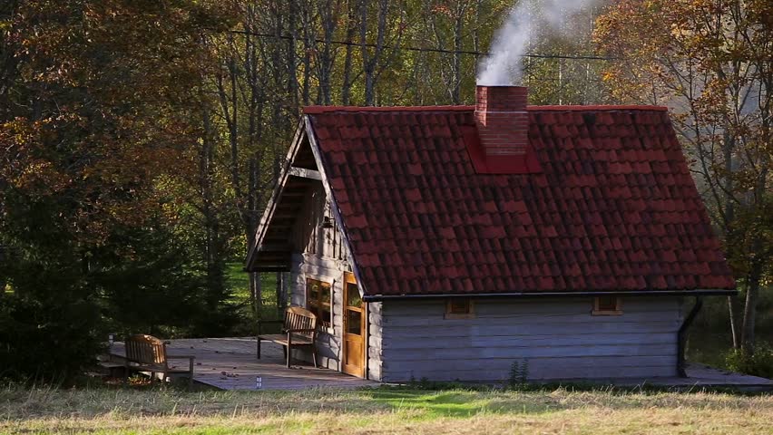 Smoke Comes from the Chimney of the Sauna with a Red Tiled Roof