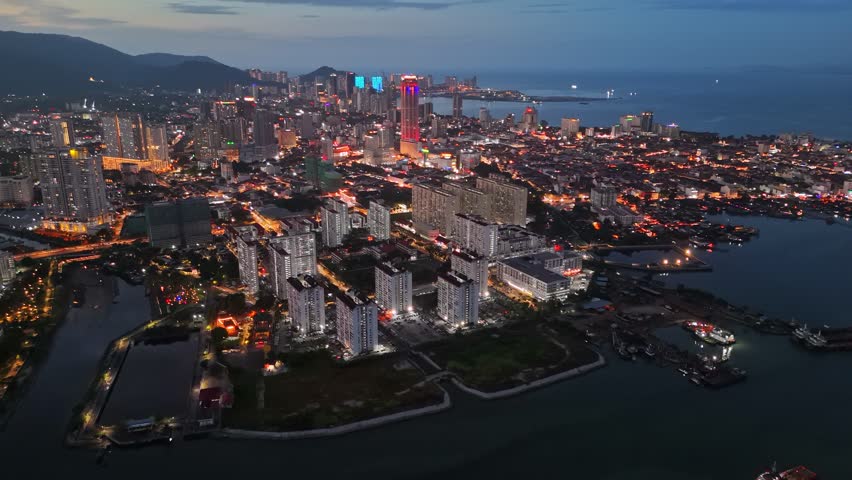 George Town, Penang, Malaysia with city lights. Flying over skyscrapers and avenues after sunset in GeorgeTown, Penang