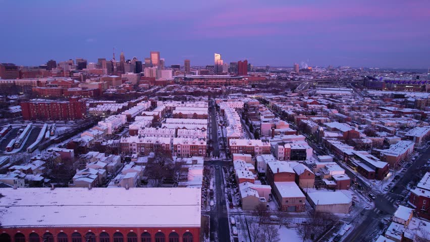 Drone Flying in Baltimore City by Snow Covered Houses at Sunset