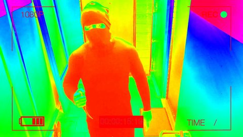 infrared hidden camera night vision recorded as the masked robber burst through the door and threatened with a knife in CCTV camera.