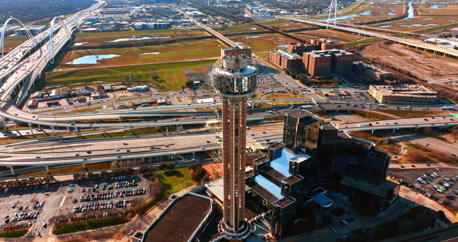 Reunion Tower Hotel in Dallas, Texas, USA. Hundreds of cars move by the multiple roads and are on the parking lots of the city. Top view.