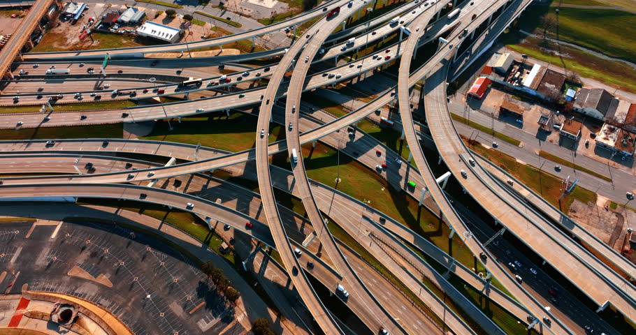 Freeways crossing in Dallas, Texas, USA. Top view on the cars going by the roads at daytime.