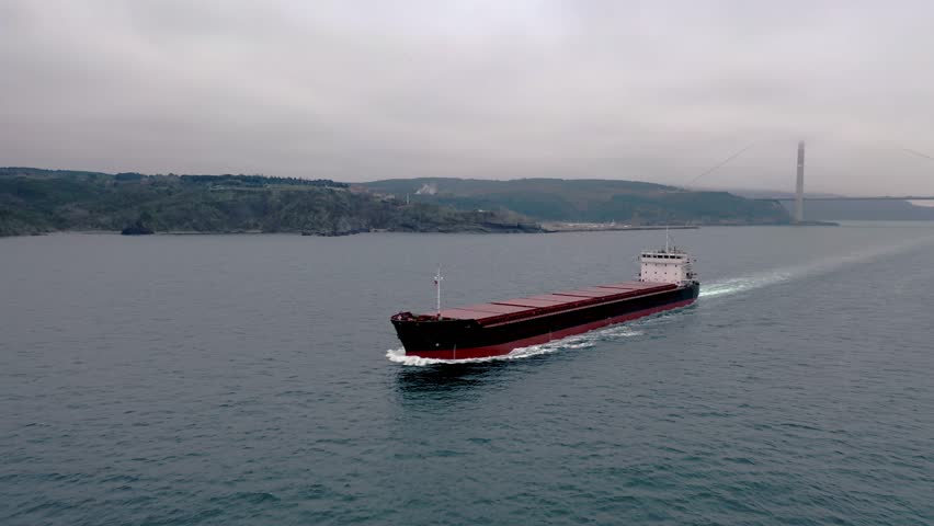 Flyover. Dry cargo ship loaded with grains underway Black Sea. A bulker carries goods and materials such as metal ore, coal, sand or timber from one port to another. Winter, Istanbul, Turkey. Drone
 Royalty-Free Stock Footage #3429735833