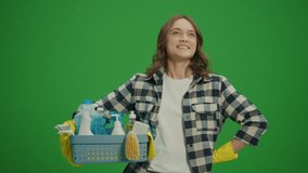Green Screen. A Smiling Young Woman in Yellow Protective Rubber Gloves Holding a Box With Cleaning Products and Satisfied with the Result of Her Cleaning. Pet-friendly Cleaning Solutions. - Powered by Shutterstock - Get 15% off with code: PIKWIZARD15