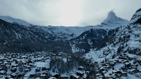 The town and Ski resort Zermatt, Switzerland aerial Drone video with the matterhorn and Alps mountains in the background.