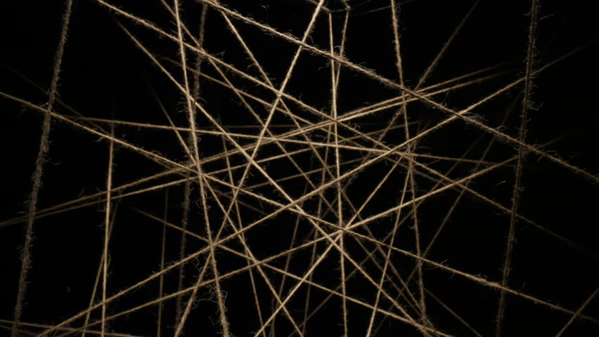 Macro dolly shot camera flies through sisal ropes, threads plexus lighted with spot light on black background, twine lines in dark, abstract chaotic interweaving, background for titles or logo Royalty-Free Stock Footage #3429751405