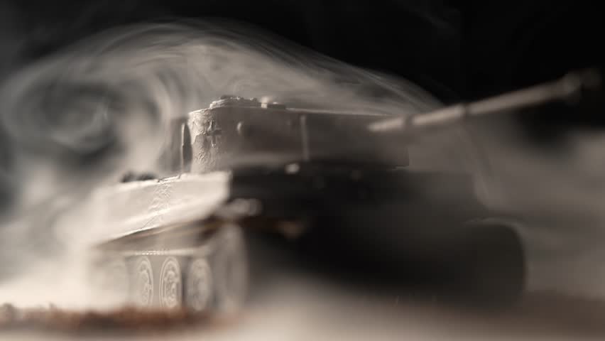 A miniature tank from World War II on a black background with rising smoke, a model of the Tiger I tank, a frontal view of the tank Royalty-Free Stock Footage #3429752811
