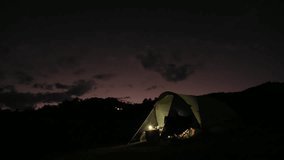 A woman cooking dinner inside the tent at night - Powered by Shutterstock - Get 15% off with code: PIKWIZARD15