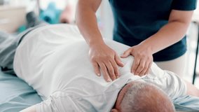Physiotherapy, back massage and chiropractor with senior man in medical office at clinic. Rehabilitation, patient and closeup of healthcare worker helping elderly male person by healing muscle pain. - Powered by Shutterstock - Get 15% off with code: PIKWIZARD15