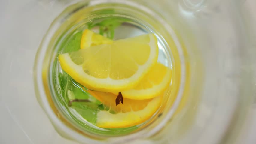 Refreshing drink in a glass of lemon with mint mojito, close-up. View from above, cocktail