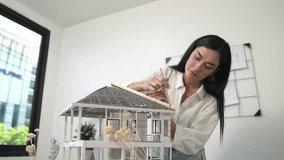 Professional young beautiful architect engineer using ruler and pencil measuring model roof length at modern office with blueprint pinned behind. Creative design and living concept. Immaculate. - Powered by Shutterstock - Get 15% off with code: PIKWIZARD15