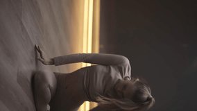 Choreography, sporty woman dance in a sports room, flexible woman performs a beautiful stretching dance with yoga elements, vertical video for social networks, soft focus.
