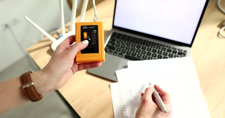 Woman checks speed of Internet connection with a tester connected to router. Portable tester for Ethernet network cable of RJ-45 cables Royalty-Free Stock Footage #3430016829