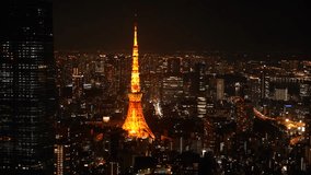 Aerial View of Japanese skycrapers from Roppongi, Tokyo, Japan at night. Scenery of central downtown area with Tokyo Tower and business district. High quality 4k footage