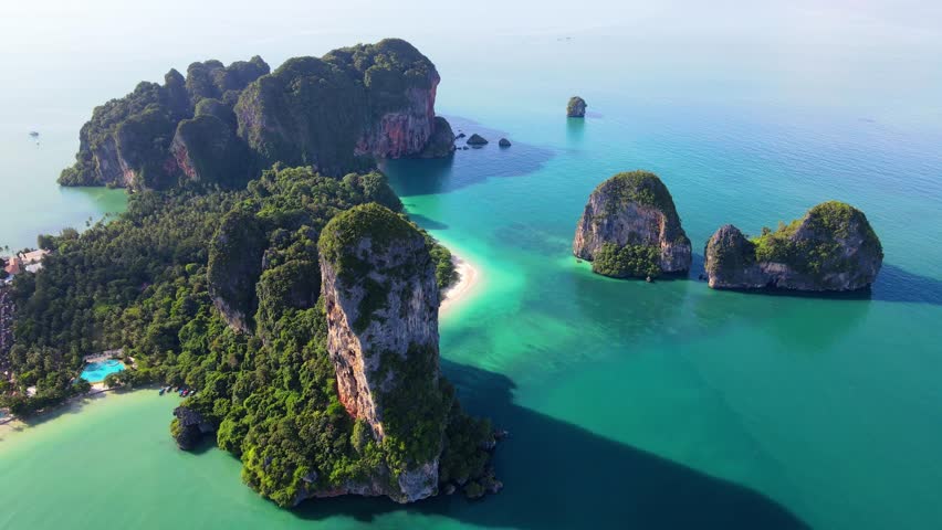 Railay Beach Krabi Thailand a tropical beach with a turqouse colored ocean, Railay Krabi view from a drone of idyllic Railay Beach in Thailand in the evening at sunset with a cloudy sky Royalty-Free Stock Footage #3430032471