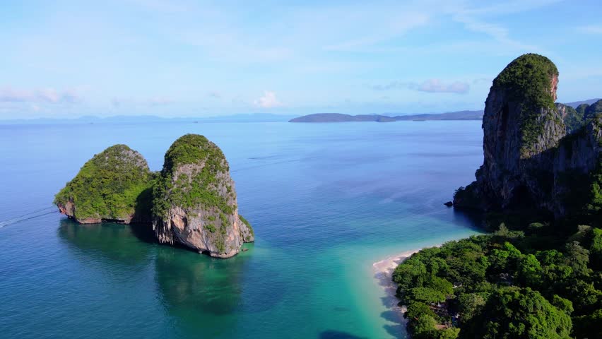 Railay Beach Krabi Thailand a tropical beach with a turqouse colored ocean, Railay Krabi view from a drone of idyllic Railay Beach in Thailand in the evening at sunset with a cloudy sky Royalty-Free Stock Footage #3430032961