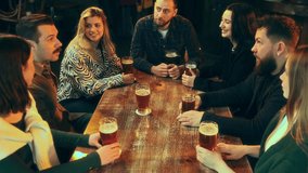 Group of young positive people, friends drinking beer, meeting in pub, laughing, talking and spending good time. Concept of leisure time, friendship, fun and joy, youth, enjoyment - Powered by Shutterstock - Get 15% off with code: PIKWIZARD15