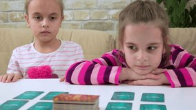 Two girlfriends are playing a card board game at home - Powered by Shutterstock - Get 15% off with code: PIKWIZARD15