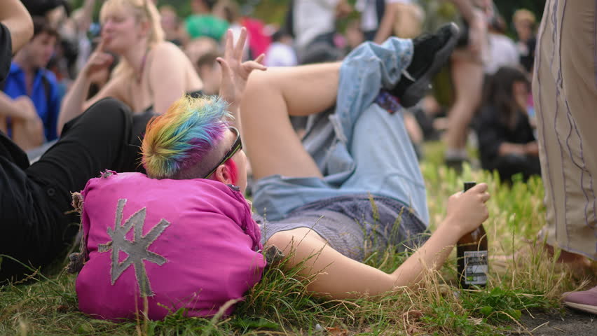 Stylish rainbow dyed hair. Joy student have fun. Drunk bi girl hold drink beer bottle. Lgbt party chill. Non-binary gay lie grass park. Csd fest day. Woman hang out gen z love pride. Free coming out.
