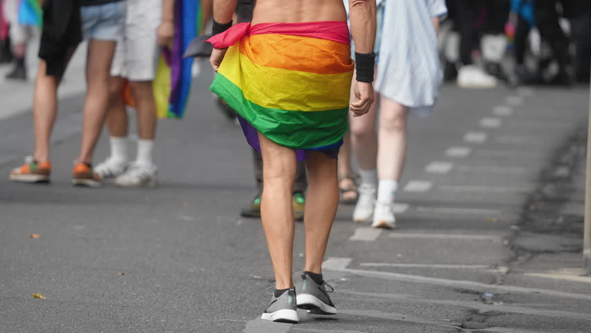 People enjoy lgbt pride parade. Same sex love concept. Dressed up bi man wear rainbow flag. Joy free gay go walk city street. Happy csd lgbtq fest. Fun coming out party. Queer culture festival month.