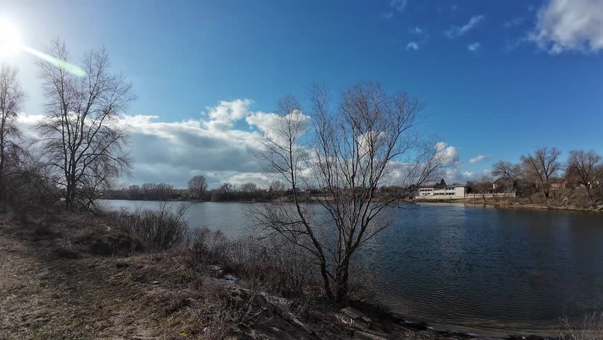 landscape on the river bank. Dnepr River. Ukrainian landscape. Strong wind on the river. Beautiful clouds. Landscape with blue sky and water. Natural landscape on a clear day on the shore. Royalty-Free Stock Footage #3430151857