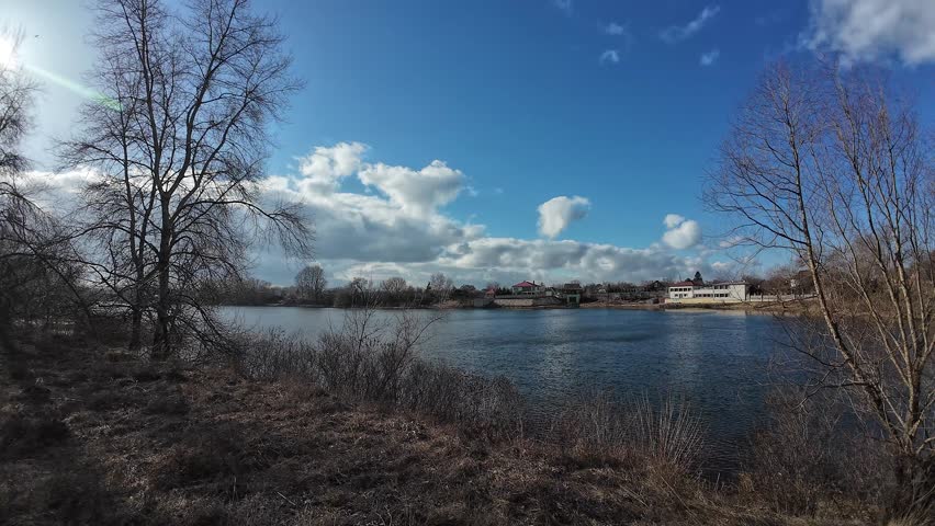 landscape on the river bank. Dnepr River. Ukrainian landscape. Strong wind on the river. Beautiful clouds. Landscape with blue sky and water. Natural landscape on a clear day on the shore. Royalty-Free Stock Footage #3430152635