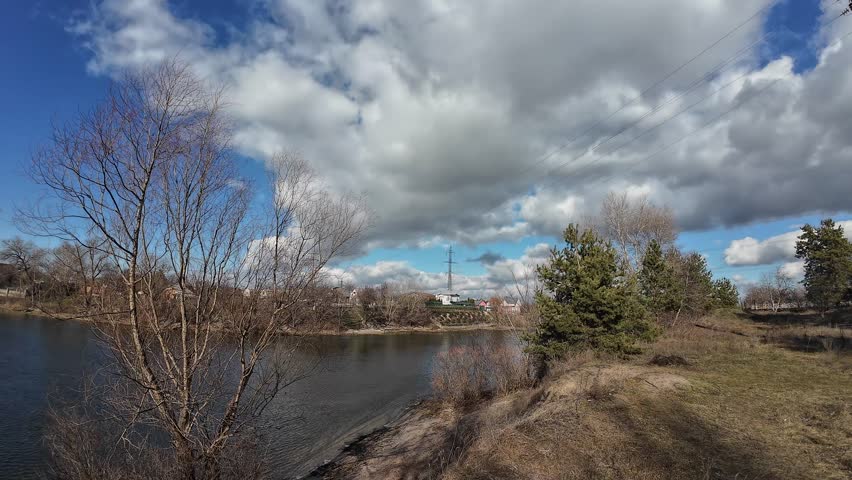 landscape on the river bank. Dnepr River. Ukrainian landscape. Strong wind on the river. Beautiful clouds. Landscape with blue sky and water. Natural landscape on a clear day on the shore. Royalty-Free Stock Footage #3430152643
