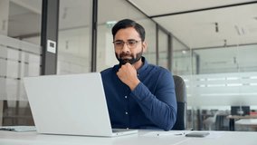 Busy Indian professional business man employee using laptop working in office. Professional financial analyst typing on computer technology working with ai solutions sitting at office desk. - Powered by Shutterstock - Get 15% off with code: PIKWIZARD15
