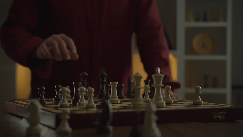 Strategic struggle in a chess game. Leadership is demonstrated between two opponents in a duel on a chessboard. A professional chess player confidently moves a piece, striving for dominance Royalty-Free Stock Footage #3430212087