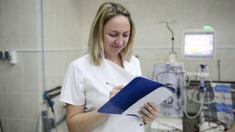 a female doctor records the data of the disease